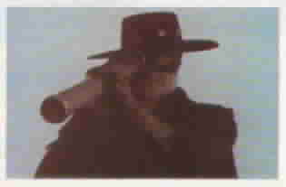 #89 Zorro watches the pueblo through a spyglass.